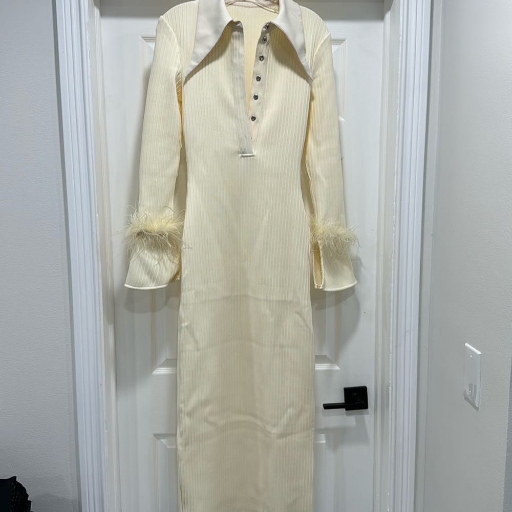 Be unique in this cream colored dress with fur sleeves